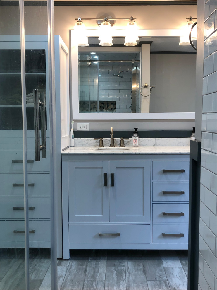 Example of a master bathroom design with granite countertops and multicolored countertops