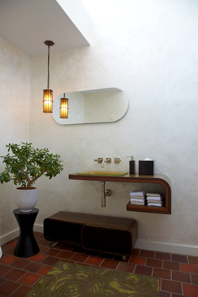 Design ideas for an asian powder room in New York with wood benchtops, terra-cotta floors, a drop-in sink and brown benchtops.