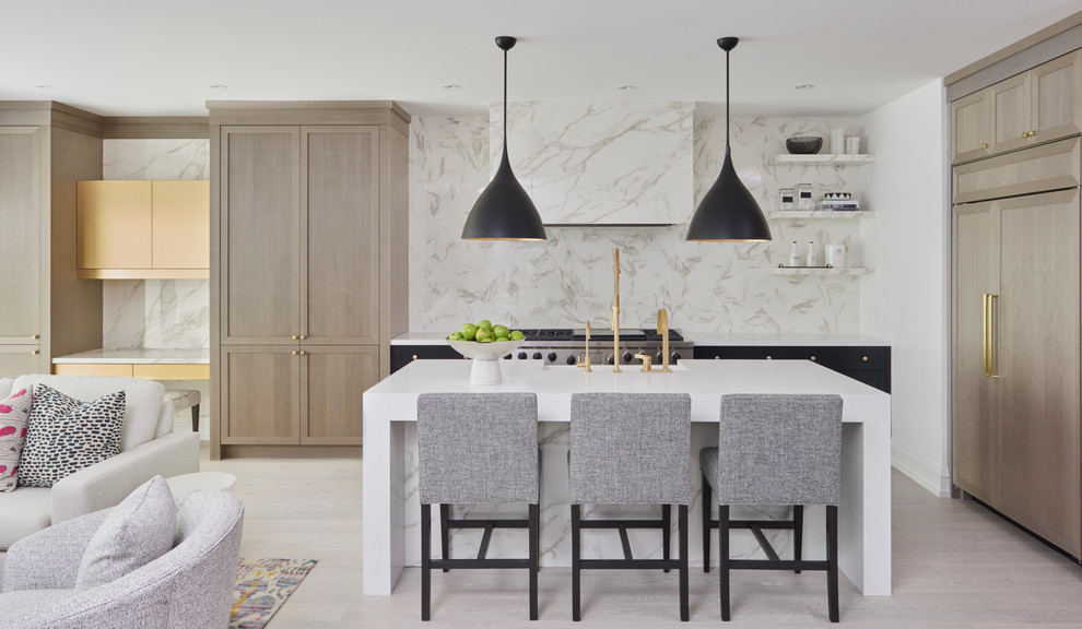 Contemporary open plan kitchen in Toronto with shaker cabinets, light wood cabinets, white splashback, panelled appliances, light hardwood floors, with island and beige floor.