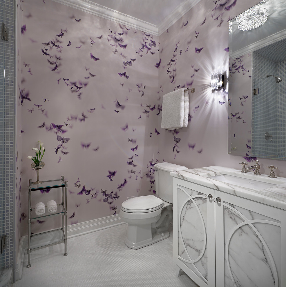 This is an example of a mid-sized transitional kids bathroom in Chicago with an undermount sink, white cabinets, an alcove shower, a two-piece toilet, purple walls, mosaic tile floors, white tile, mosaic tile, marble benchtops and recessed-panel cabinets.