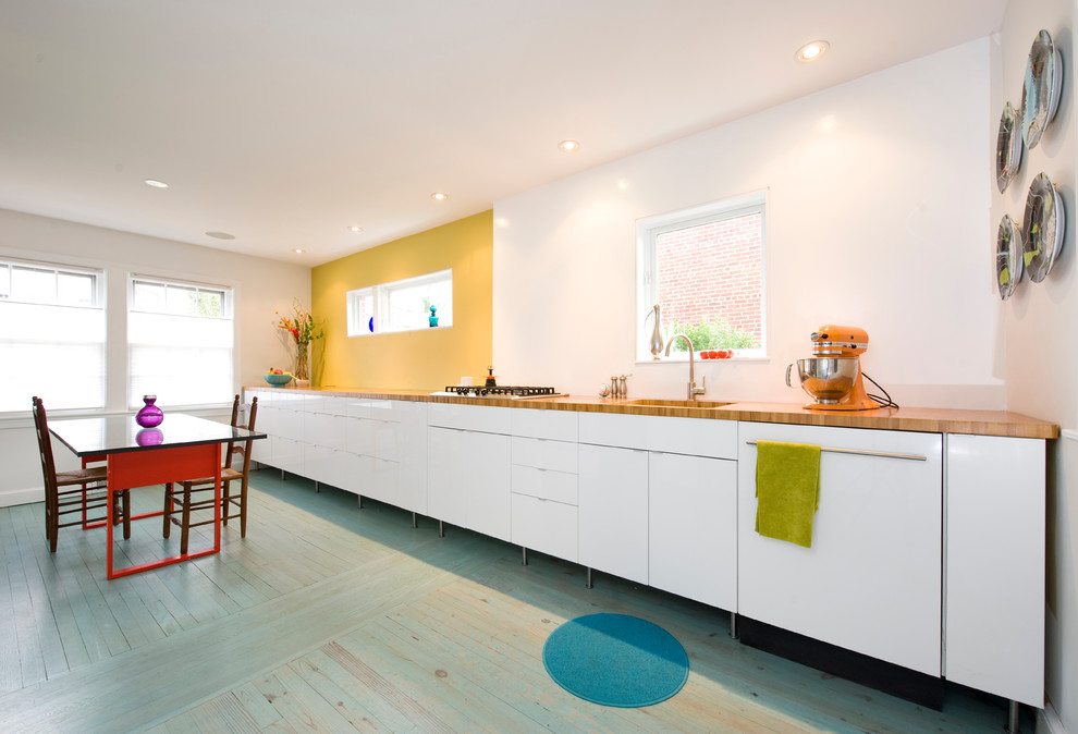 Scandinavian single-wall eat-in kitchen in DC Metro with flat-panel cabinets, white cabinets, wood benchtops, painted wood floors and turquoise floor.