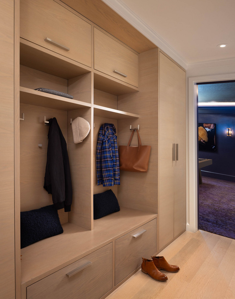 This is an example of an expansive transitional dressing room in San Francisco with flat-panel cabinets and light wood cabinets.