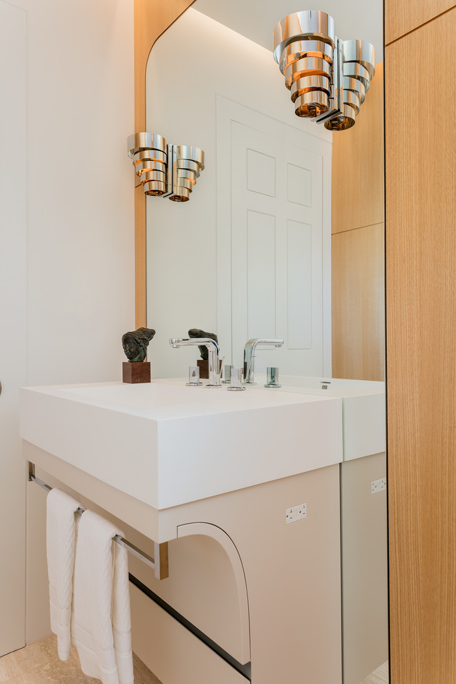 Photo of a contemporary 3/4 bathroom in Boston with medium wood cabinets, a wall-mount toilet, beige tile, glass tile, white walls, marble floors, a wall-mount sink and solid surface benchtops.