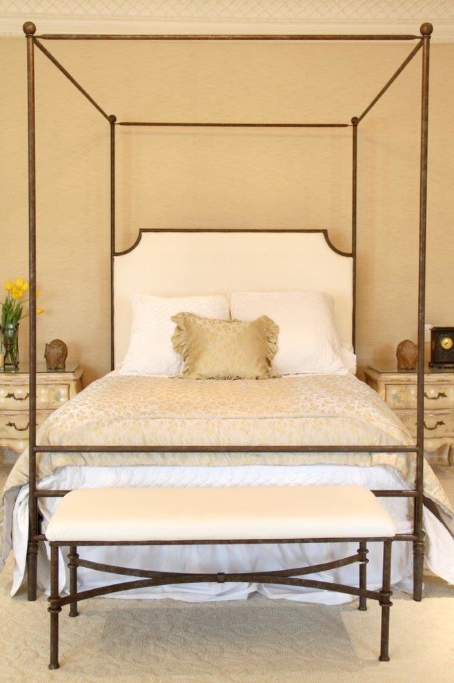 Photo of a large traditional master bedroom in Los Angeles with beige walls.