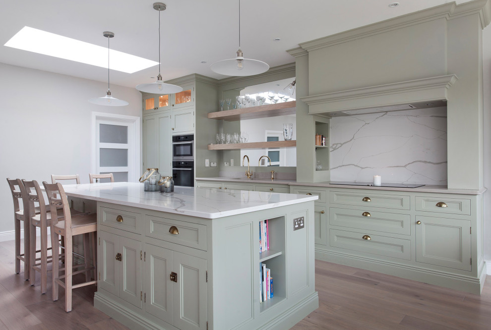 Inspiration for a mid-sized single-wall eat-in kitchen in Other with recessed-panel cabinets, green cabinets, wood benchtops, with island and white benchtop.