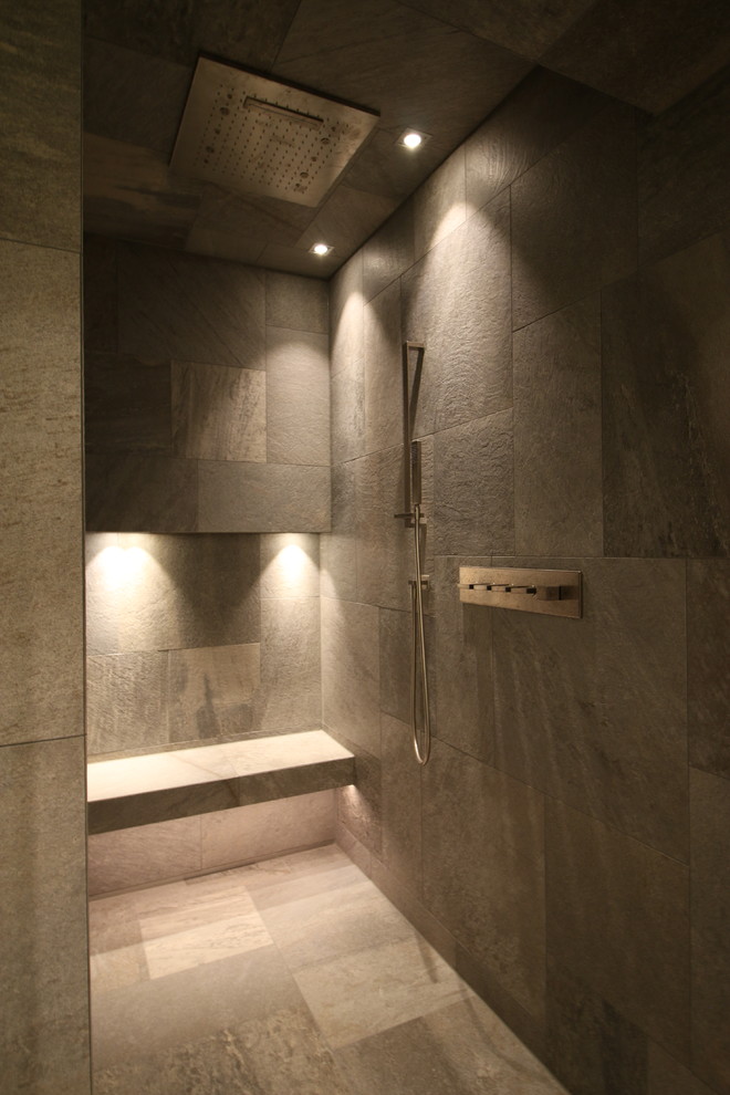 Photo of a large contemporary bathroom in Cologne with flat-panel cabinets, dark wood cabinets, a freestanding tub, an open shower, a two-piece toilet, gray tile, ceramic tile, black walls, ceramic floors, with a sauna, a trough sink, granite benchtops, grey floor, an open shower and black benchtops.