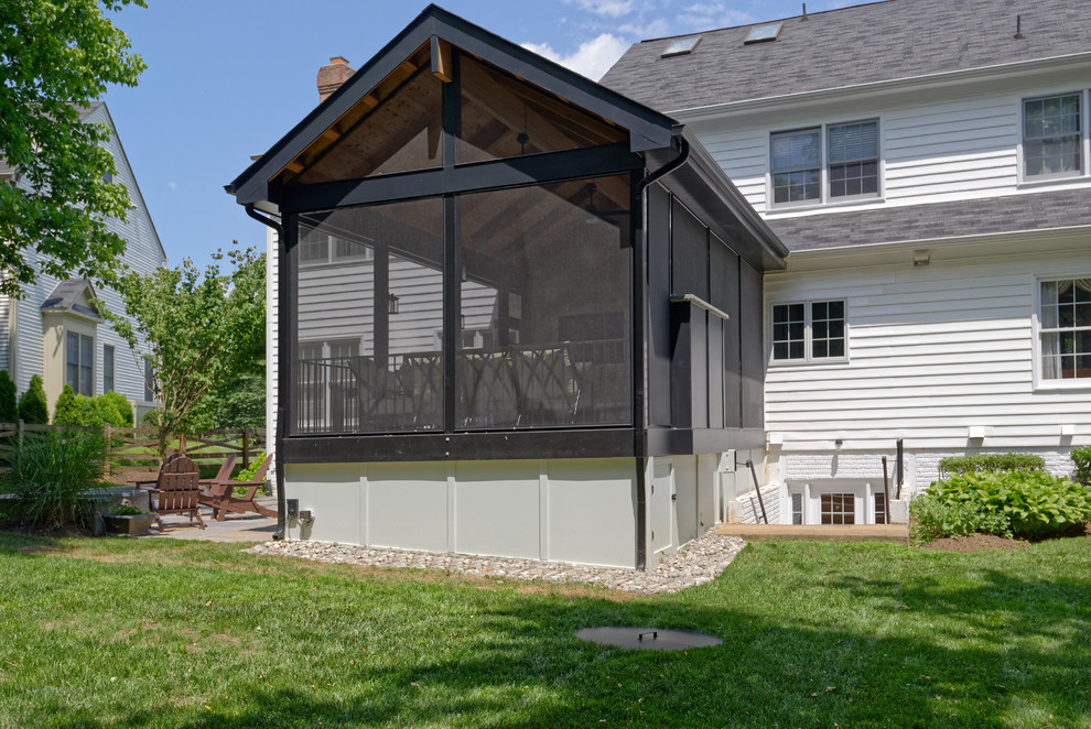 This is an example of a mid-sized country backyard verandah in DC Metro with a fire feature and decking.