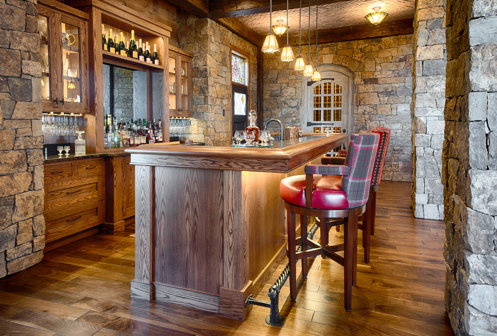 Example of a tuscan home bar design in Minneapolis