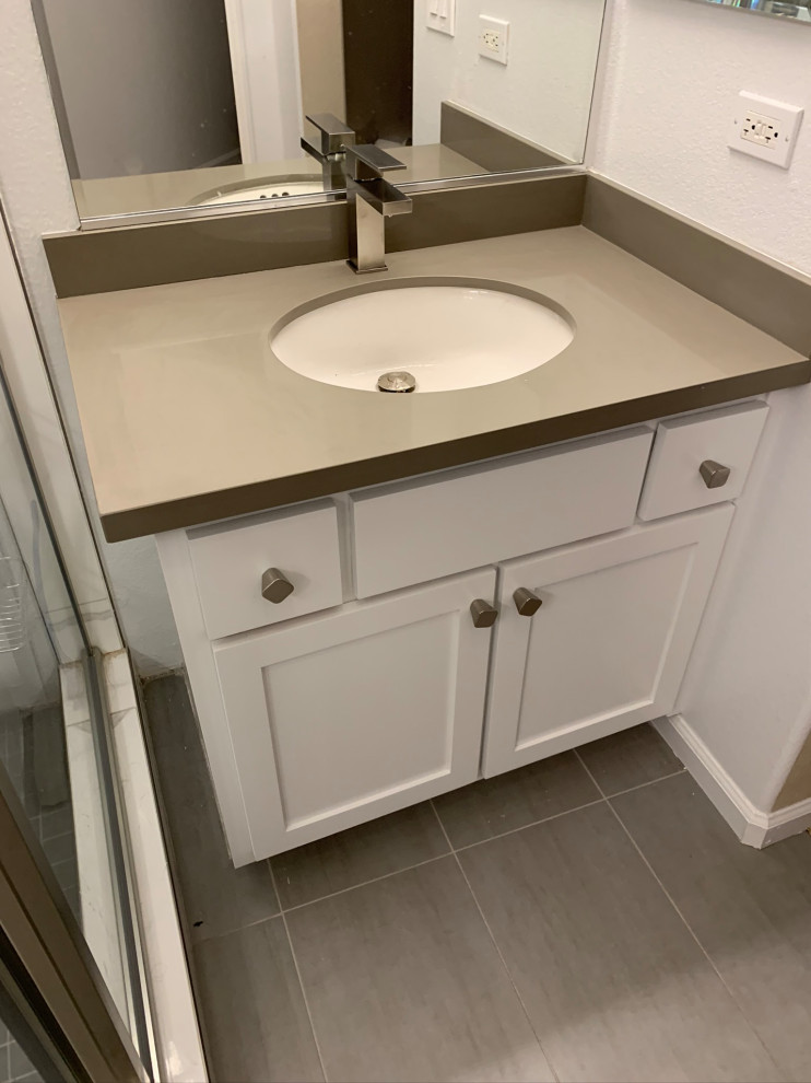 Mid-sized contemporary master bathroom in San Francisco with shaker cabinets, white cabinets, a corner shower, a one-piece toilet, white tile, porcelain tile, white walls, porcelain floors, an undermount sink, engineered quartz benchtops, grey floor, a hinged shower door, grey benchtops, a niche, a double vanity and a built-in vanity.