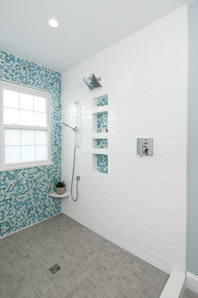 Inspiration for a large beach style wet room bathroom in Philadelphia with flat-panel cabinets, white cabinets, a drop-in tub, a bidet, blue tile, mosaic tile, blue walls, porcelain floors, an undermount sink, engineered quartz benchtops, grey floor, an open shower and white benchtops.