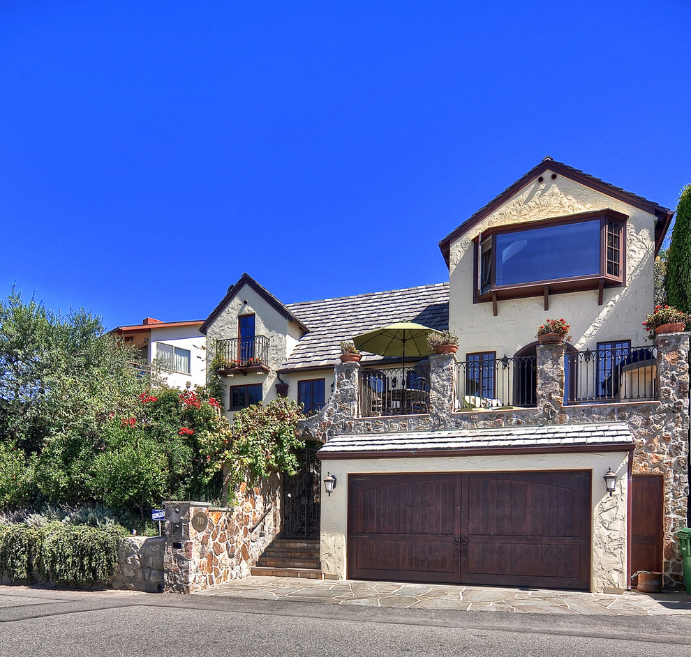 Mid-sized mediterranean two-storey stucco beige exterior in Orange County with a clipped gable roof.