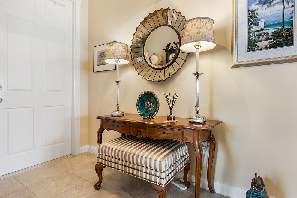 Inspiration for a mid-sized transitional porcelain tile and beige floor foyer remodel in Miami with beige walls and a white front door