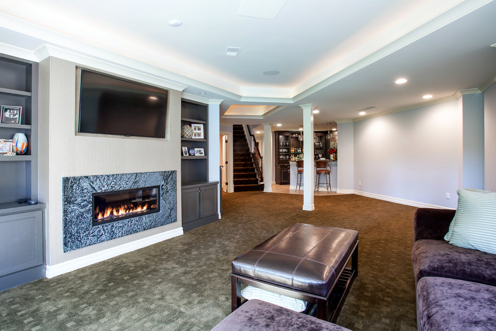 Traditional basement in Detroit with blue walls, carpet, a ribbon fireplace and a stone fireplace surround.