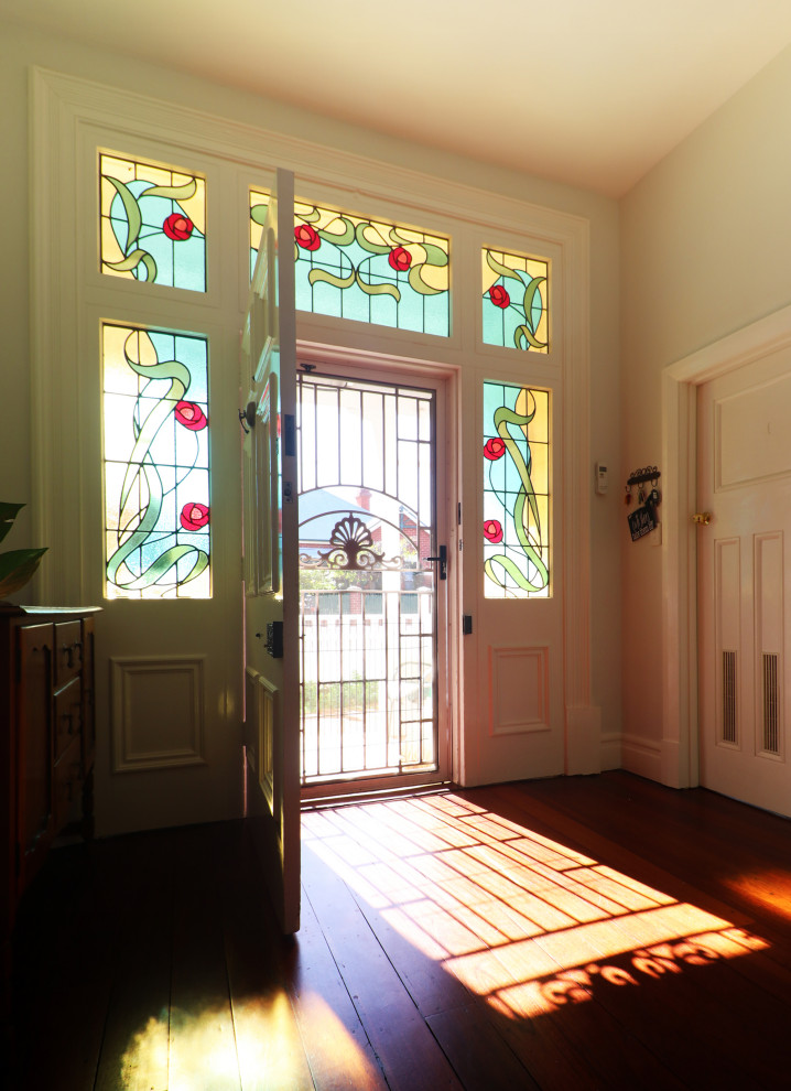 Inspiration for a large traditional entryway in Perth with white walls, dark hardwood floors and a red front door.
