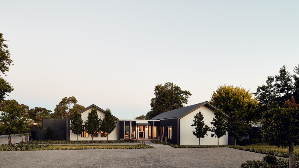 Inspiration for a large contemporary one-storey black house exterior in Melbourne with metal siding, a gable roof and a metal roof.