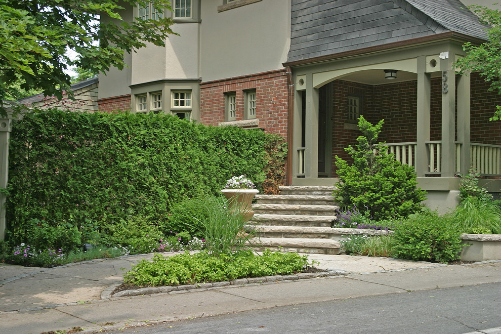 This is an example of a small transitional partial sun front yard stone garden path in Toronto for summer.