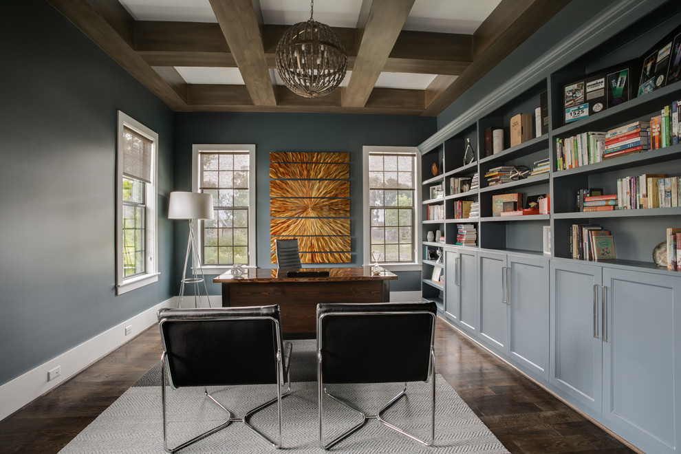 Photo of a large transitional study room in Houston with blue walls, a freestanding desk, dark hardwood floors, no fireplace and brown floor.