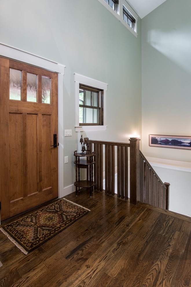 Design ideas for a mid-sized transitional hallway in Other with grey walls, medium hardwood floors and brown floor.