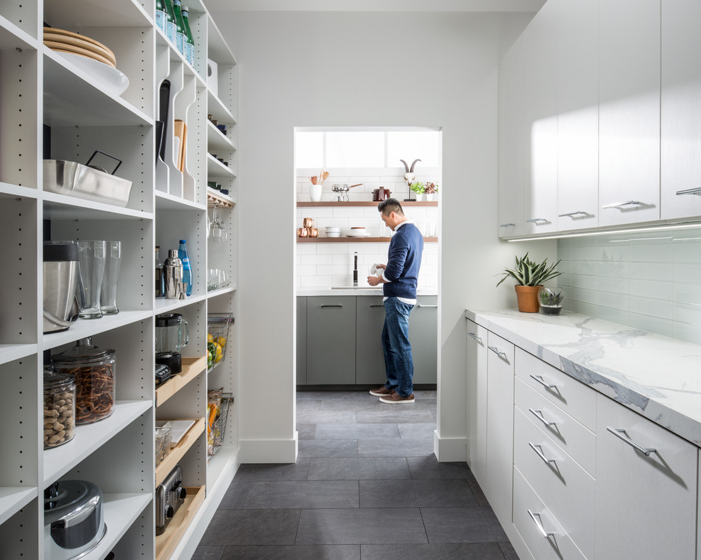 Design ideas for a large contemporary galley kitchen pantry in Other with flat-panel cabinets, white cabinets, marble benchtops, grey splashback, subway tile splashback and porcelain floors.