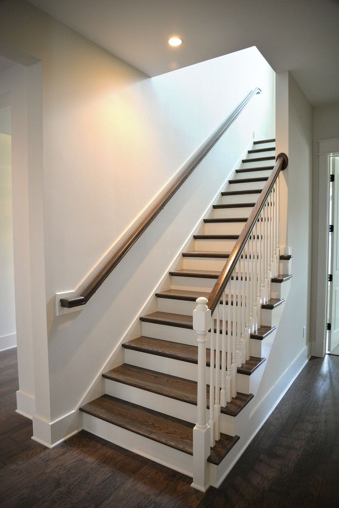 This is an example of a large country wood l-shaped staircase in Jacksonville with painted wood risers.