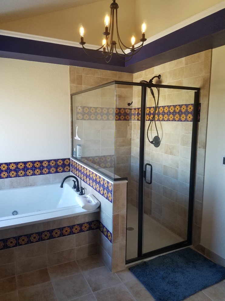 This is an example of a large master bathroom in Denver with raised-panel cabinets, dark wood cabinets, a drop-in tub, a curbless shower, multi-coloured tile, ceramic tile, ceramic floors, an undermount sink, solid surface benchtops, a hinged shower door and white benchtops.
