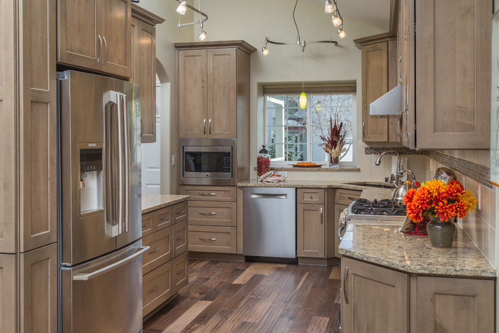 Eat-in kitchen - mid-sized transitional galley medium tone wood floor eat-in kitchen idea with an undermount sink, recessed-panel cabinets, gray cabinets, quartz countertops, beige backsplash, ceramic backsplash, stainless steel appliances and no island