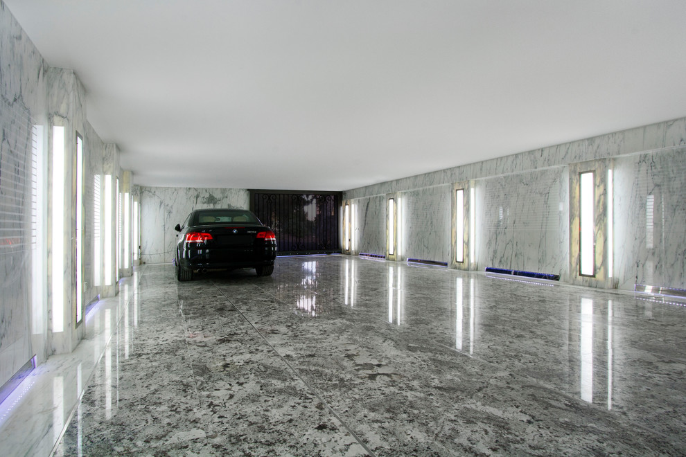 This is an example of a large transitional attached four-car garage in Nice.