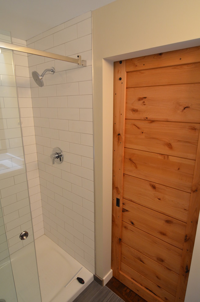 Small contemporary 3/4 bathroom in Seattle with flat-panel cabinets, dark wood cabinets, an alcove shower, a two-piece toilet, white tile, porcelain tile, porcelain floors, an undermount sink and engineered quartz benchtops.