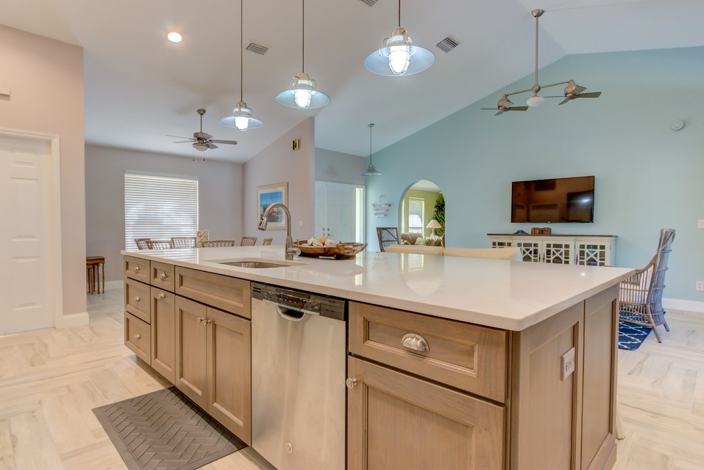 Large single-wall porcelain tile and white floor open concept kitchen photo with an undermount sink, shaker cabinets, white cabinets, quartz countertops, blue backsplash, stainless steel appliances, an island and white countertops