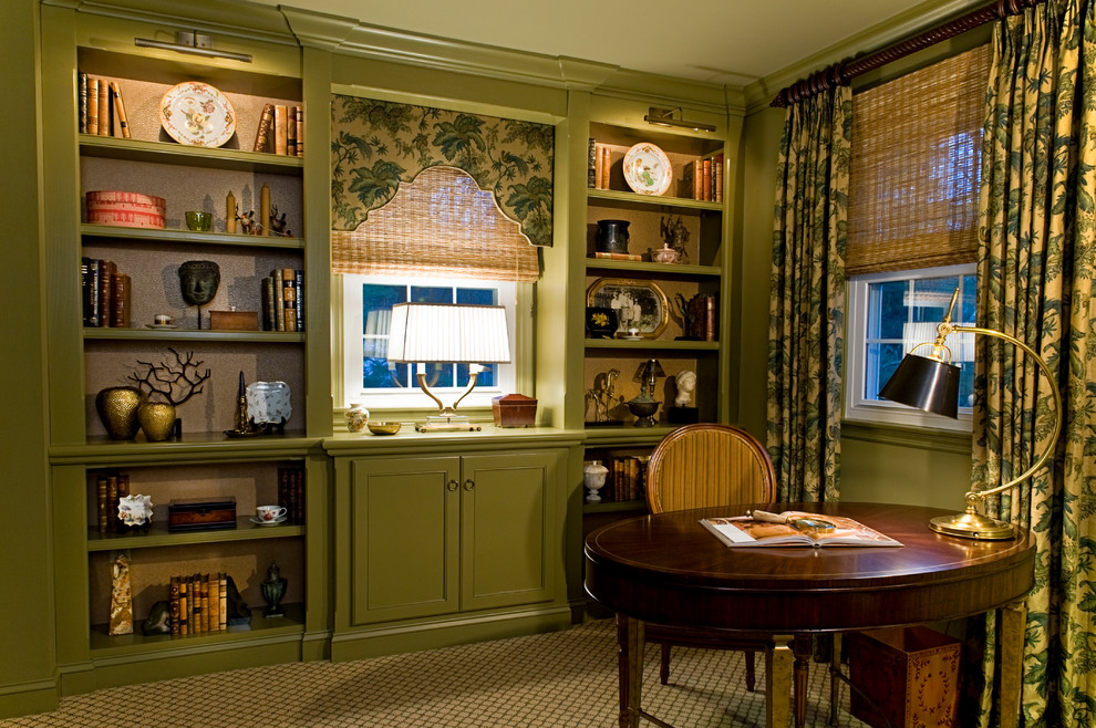This is an example of a small traditional study room in Philadelphia with green walls, carpet and a freestanding desk.