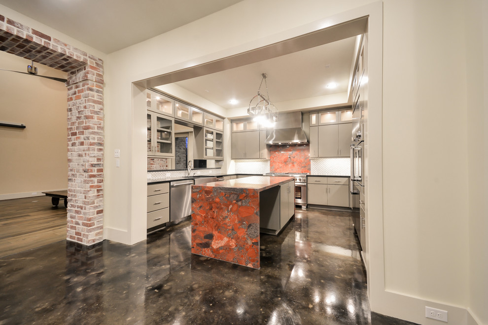 Example of a mid-sized transitional u-shaped concrete floor eat-in kitchen design in Houston with a farmhouse sink, flat-panel cabinets, green cabinets, marble countertops, white backsplash, mosaic tile backsplash, stainless steel appliances and an island
