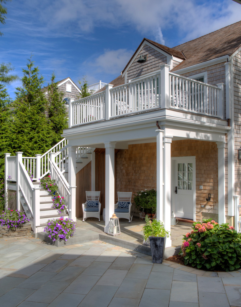Photo of a large beach style two-storey grey exterior in Boston with wood siding.