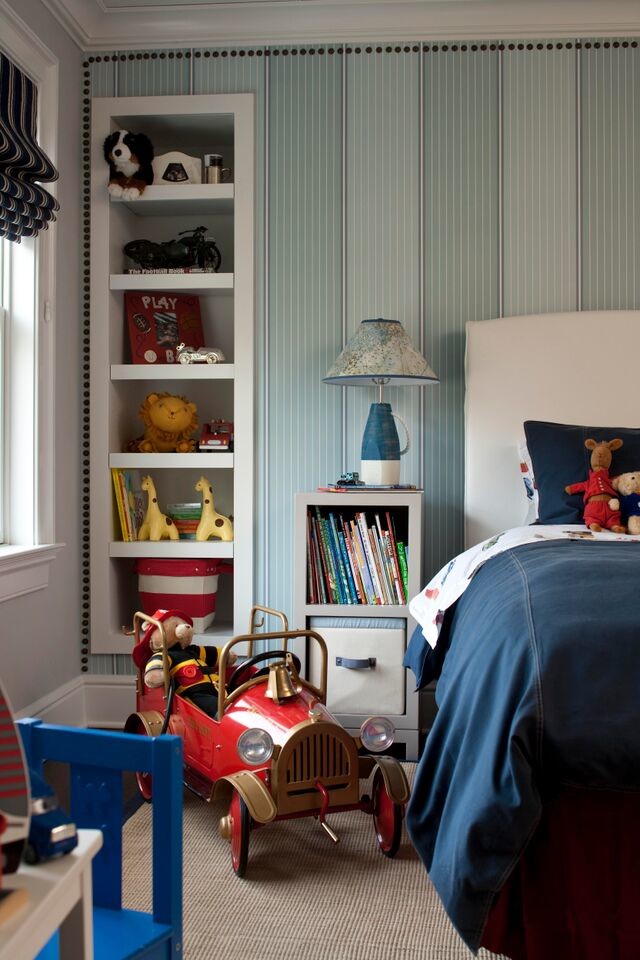 Photo of a mid-sized transitional kids' bedroom for boys in New York with blue walls, dark hardwood floors and brown floor.