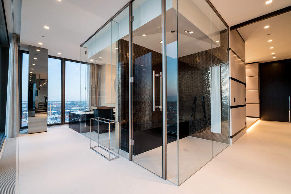 This is an example of an expansive contemporary wet room bathroom in Munich with a drop-in tub, black tile, mosaic tile, with a sauna, white floor and a hinged shower door.