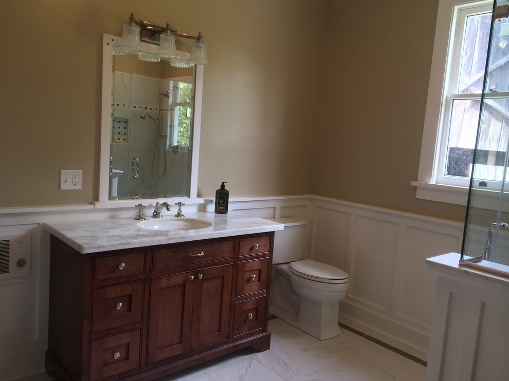 Small country master bathroom in Sacramento with an undermount sink, beaded inset cabinets, medium wood cabinets, marble benchtops, a claw-foot tub, a curbless shower, a two-piece toilet, white tile, porcelain tile, beige walls and ceramic floors.