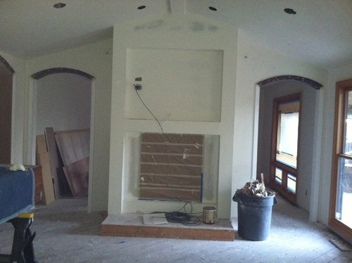 Pass Through Fireplace - Center Piece of two rooms -- Need helping selecting stone/tile/design We are putting in a double sided wood burning fireplace that sits between the family room and living room. It is in black matte finish. Two archways are on either side of it. TV above it on the LR side. We need help selecting the right stone and design for both sides. We want them related but not id...