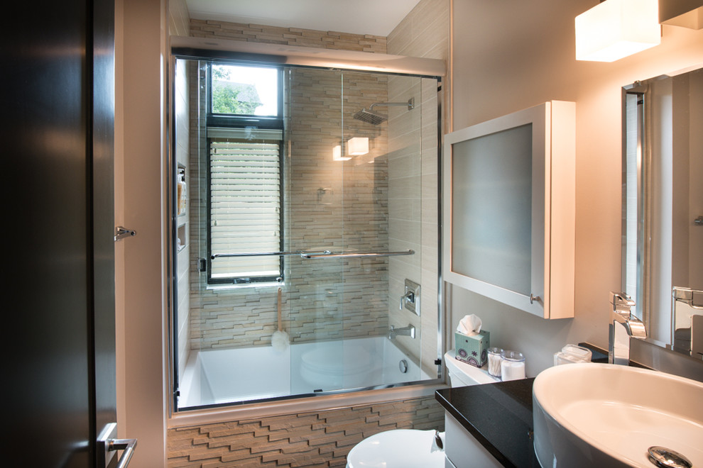 Drop-in bathtub - mid-sized transitional 3/4 beige tile and stone tile drop-in bathtub idea with flat-panel cabinets, white cabinets, a two-piece toilet, beige walls, a vessel sink and quartz countertops