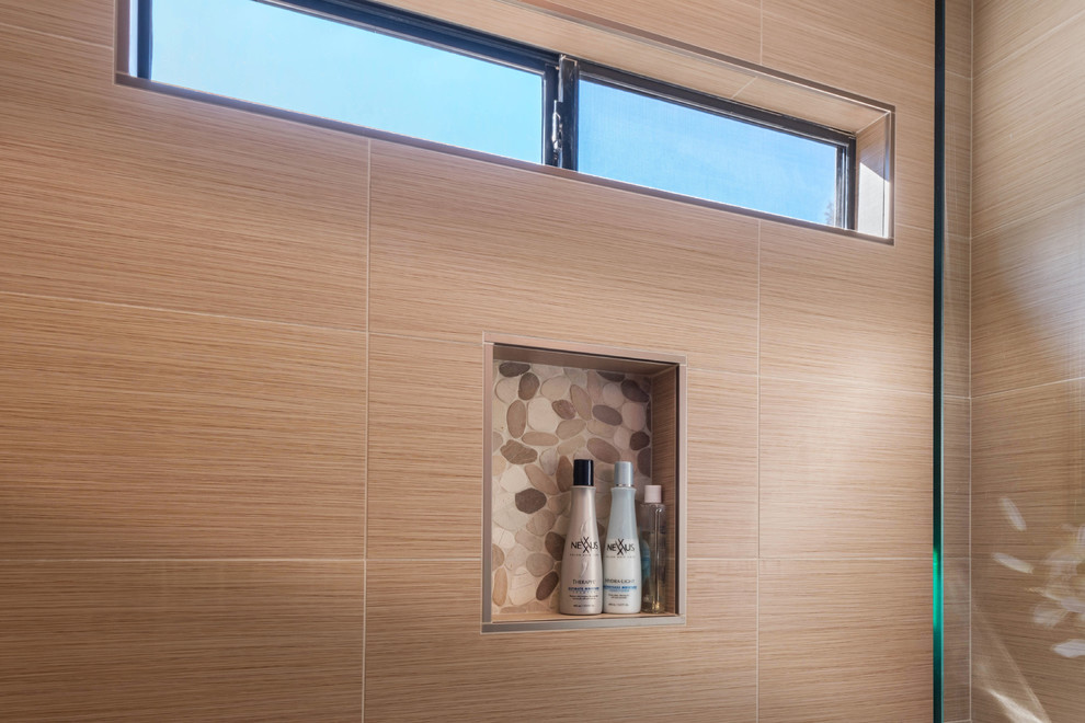 Mid-sized modern 3/4 bathroom in Other with glass-front cabinets, dark wood cabinets, an alcove shower, a two-piece toilet, brown walls, a vessel sink, beige tile, white tile and pebble tile.