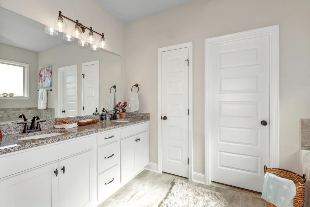 This is an example of a mid-sized traditional master bathroom in Other with white cabinets, grey walls, ceramic floors, granite benchtops, grey floor, multi-coloured benchtops, a double vanity and a built-in vanity.