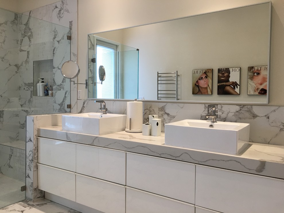 This is an example of a mid-sized contemporary master bathroom in Orange County with flat-panel cabinets, turquoise cabinets, an alcove shower, gray tile, stone tile, white walls, marble floors, a vessel sink, marble benchtops, white floor and a sliding shower screen.