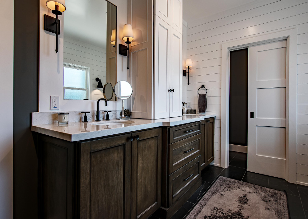 Photo of a mid-sized country master bathroom in Los Angeles with beaded inset cabinets, brown cabinets, white walls, marble floors, marble benchtops, black floor, white benchtops, a double vanity, a built-in vanity and wood walls.