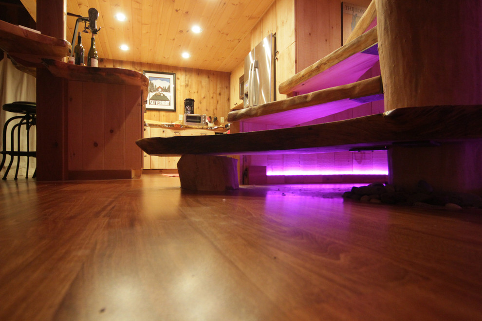 Inspiration for a mid-sized rustic wooden straight open and wood railing staircase remodel in Burlington
