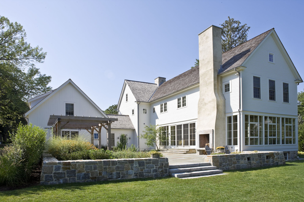 This is an example of a country exterior in New York with wood siding and a gable roof.