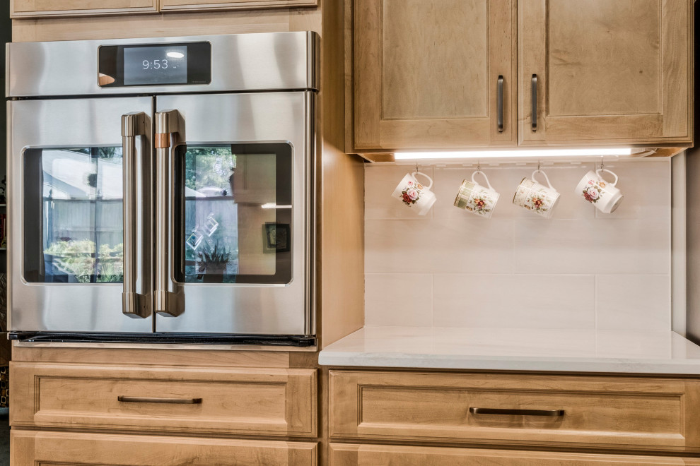Example of a huge transitional u-shaped kitchen pantry design in DC Metro with an undermount sink, recessed-panel cabinets, quartz countertops, white backsplash, subway tile backsplash, stainless steel appliances, a peninsula and white countertops