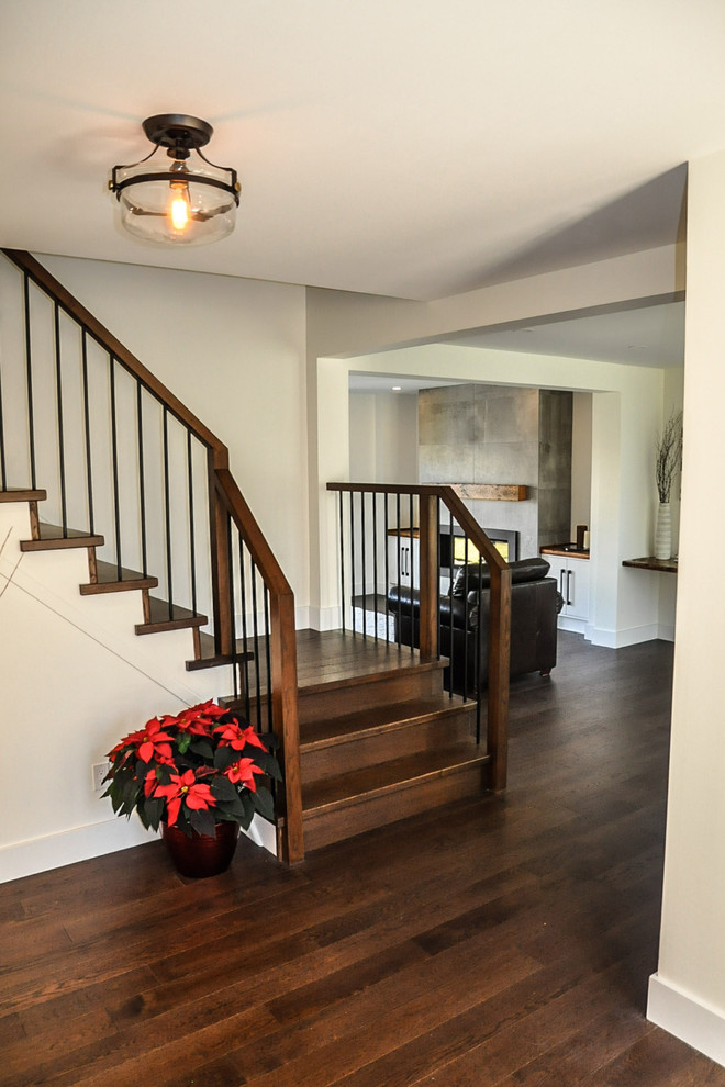 Staircase - mid-sized transitional wooden l-shaped dark wood floor, brown floor and wood railing staircase idea with white walls, a white front door and wooden risers