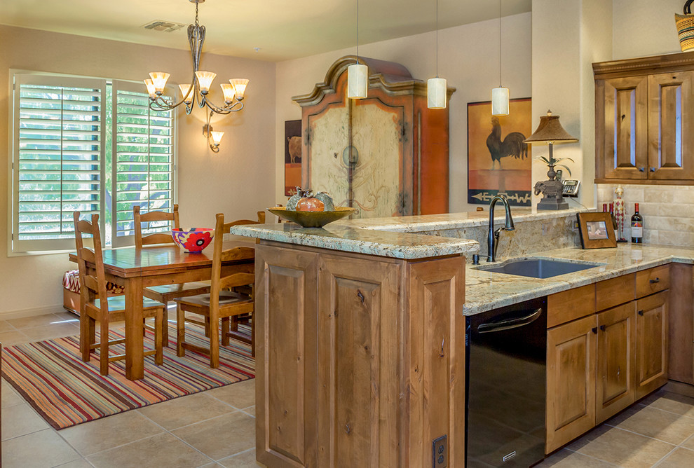 Open concept kitchen - mid-sized transitional l-shaped porcelain tile and beige floor open concept kitchen idea in Phoenix with an undermount sink, raised-panel cabinets, medium tone wood cabinets, granite countertops, beige backsplash, travertine backsplash and paneled appliances