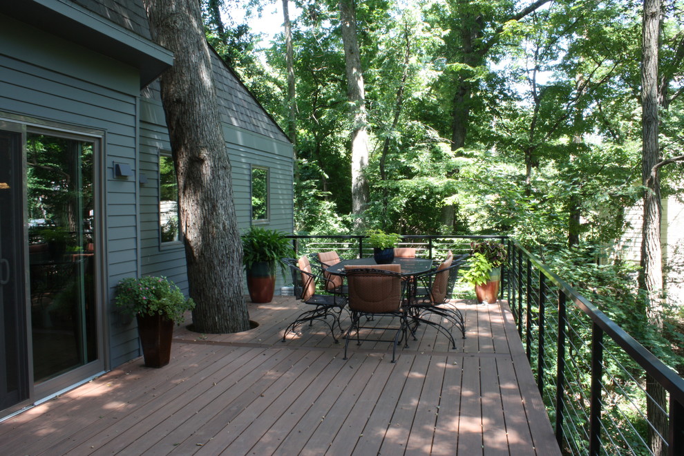 This is an example of a large midcentury backyard deck in Cedar Rapids with no cover.