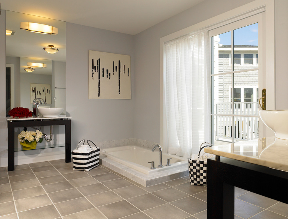 Large contemporary master bathroom in DC Metro with furniture-like cabinets, black cabinets, a drop-in tub, grey walls, ceramic floors, a vessel sink and beige floor.