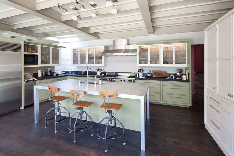 Transitional l-shaped dark wood floor kitchen photo in Austin with an undermount sink, white backsplash, stainless steel appliances, white walls, an island and green cabinets