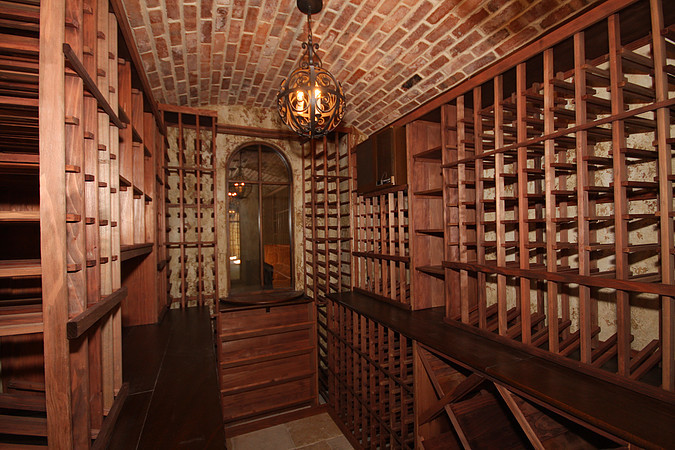 Mountain style wine cellar photo in Denver with storage racks
